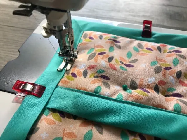 Top stitching bias tape around hot pad on sewing machine