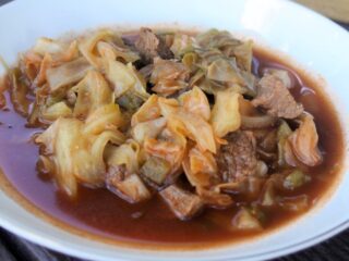 A bowl of cabbage and beef soup.