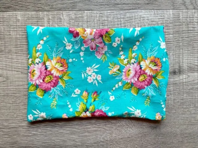 Right side out rectangle of teal floral fabric sewn with 3" opening at one end