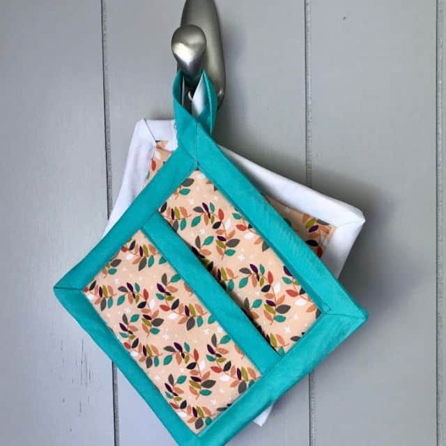 Pot holders hanging from a metal hook.
