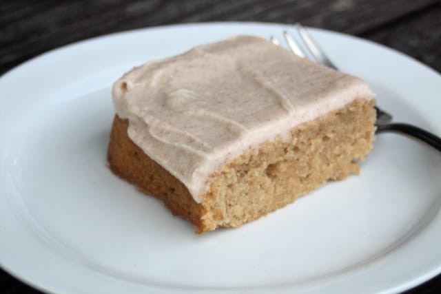 A frosted apple butter bar on a white plate with a fork.