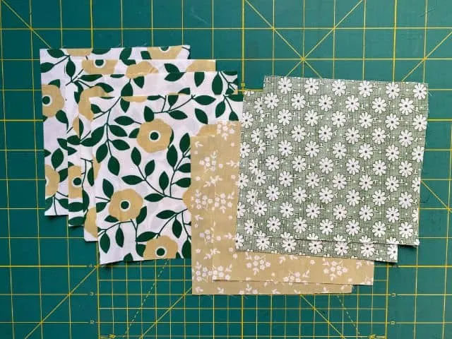 Fabric squares cut to size on cutting mat