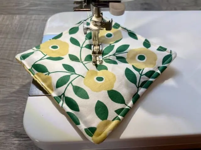 Floral mug rug on sewing machine plate with needle in center