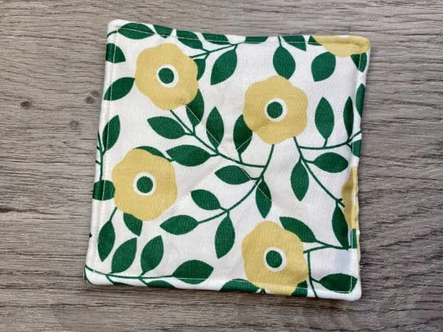 Fabric mug rug with green and tan flowers