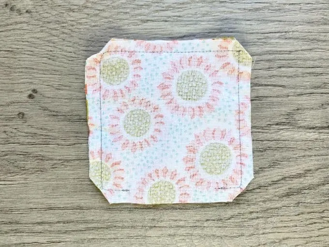 Square of fabric with corners snipped off