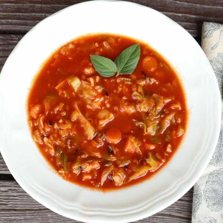 A white bowl full of cabbage roll soup as seen from above.