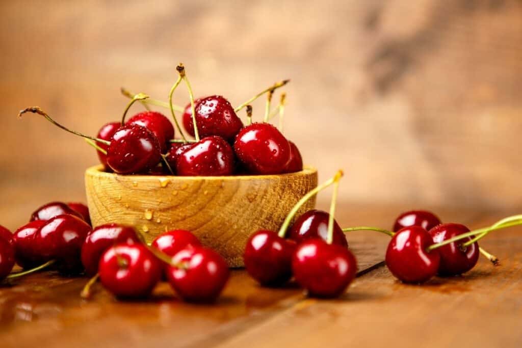 Fresh cherries in a wooden bowl.