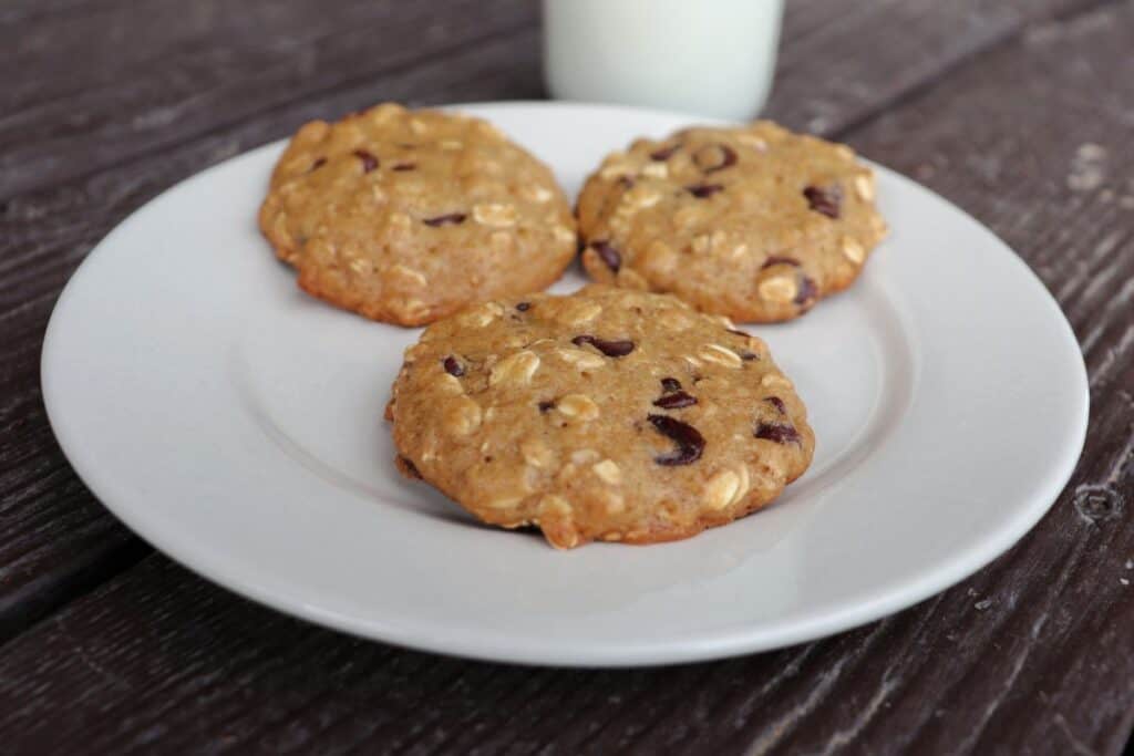 3 applesauce chocolate chip cookies scattered on a plate.