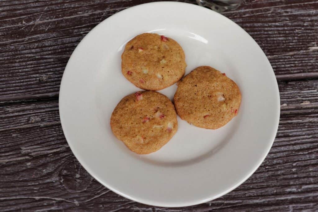 3 rhubarb cookies sitting on a white plate as seen from above.