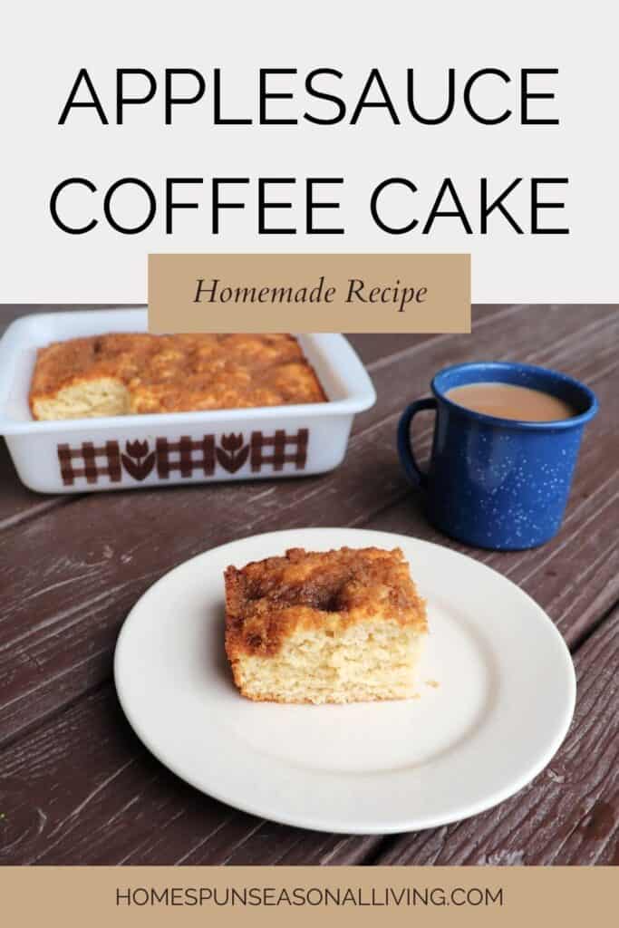 A piece of applesauce coffee cake on a white plate. A blue tin cup of coffee sits behind it, the remaining cake in square pan in the background. Text overlay reads: Applesauce Coffee Cake - Homemade recipe