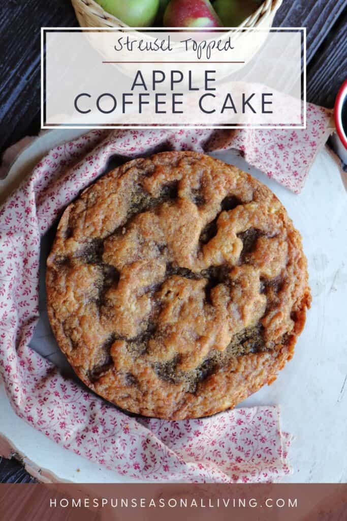 A round apple coffee cake as seen from above surrounded by a red flowered cloth. Text overlay reads: Streusel topped apple coffee cake.