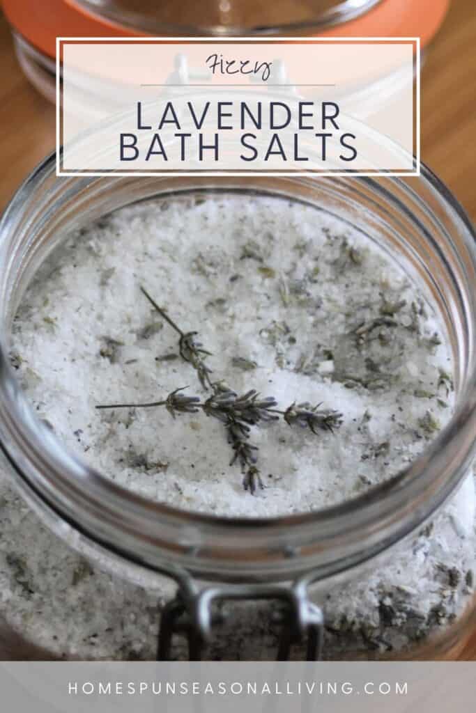 An open jar of bath salts with dried lavender stems sitting on top. Text overlay reads: Fizzy Lavender Bath Salts. 